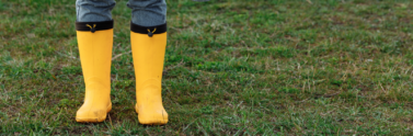 person-wearing-yellow-rainboots-outside