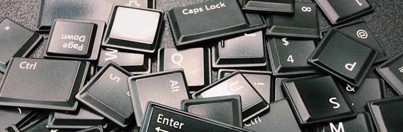 Loose black computer keys in a pile