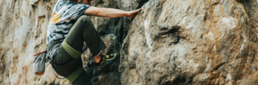 person-in-black-helmet-climbing-on-rock