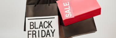 woman-in-leather-jacket-holding-shopping-bags