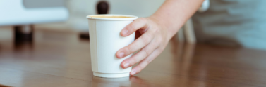 barista-serving-coffee-in-paper-cup