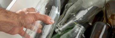 person-holding-a-clear-glass-bottle