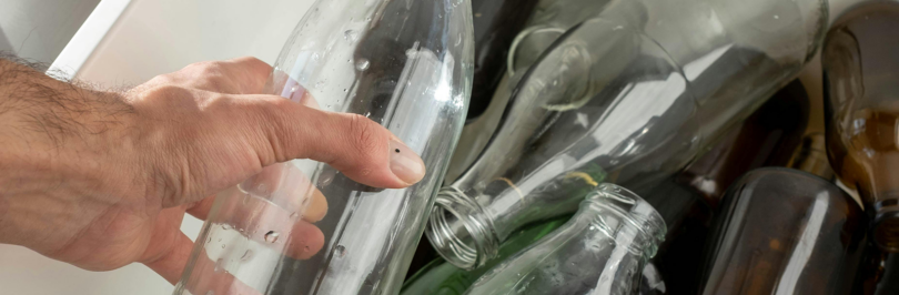 person-holding-a-clear-glass-bottle