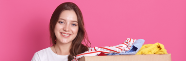 Girl holding boxes of clothes