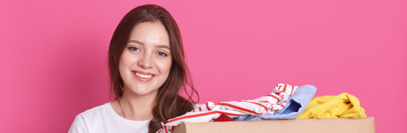 Girl holding boxes of clothes