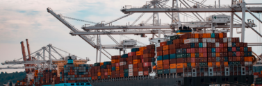 Barge with shipping containers at a port