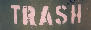 the word trash written across a trash can