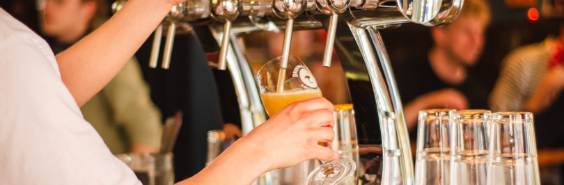 Bartender pouring beer into glass